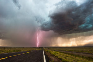 Dark clouds and lightning fill the sky ahead of a severe storm moving across the plains.