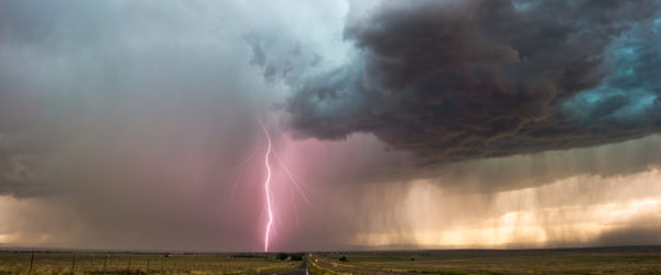 Dark clouds and lightning fill the sky ahead of a severe storm moving across the plains.