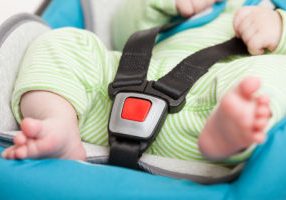 Little baby child in safety car seat